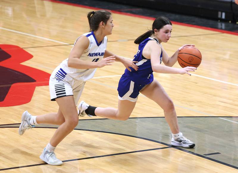 Hinckley-Big Rock's Mia Cotton drives by Newark’s Brooklyn Hatteberg Thursday, Jan. 18, 2024, during the Little 10 girls basketball tournament at Indian Creek High School in Shabbona.