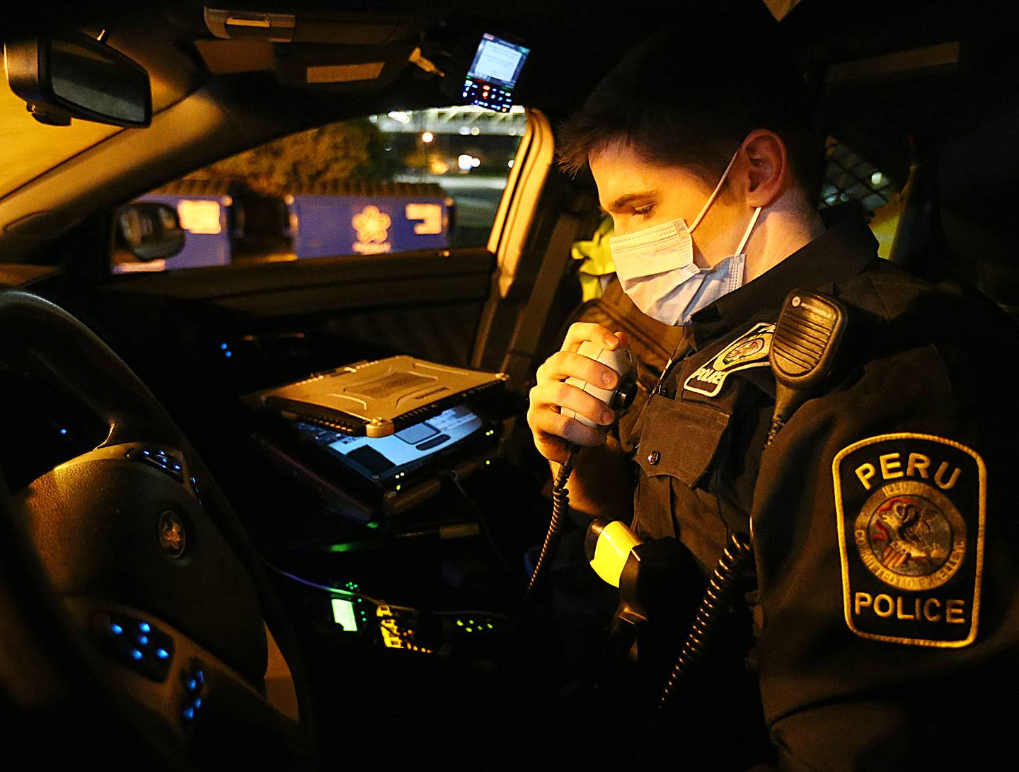 Peru Police officer Brendan Sheedy, radios to dispatch in his squad car. Sheedy holds the record for busting the most DUI's in a year at the department.