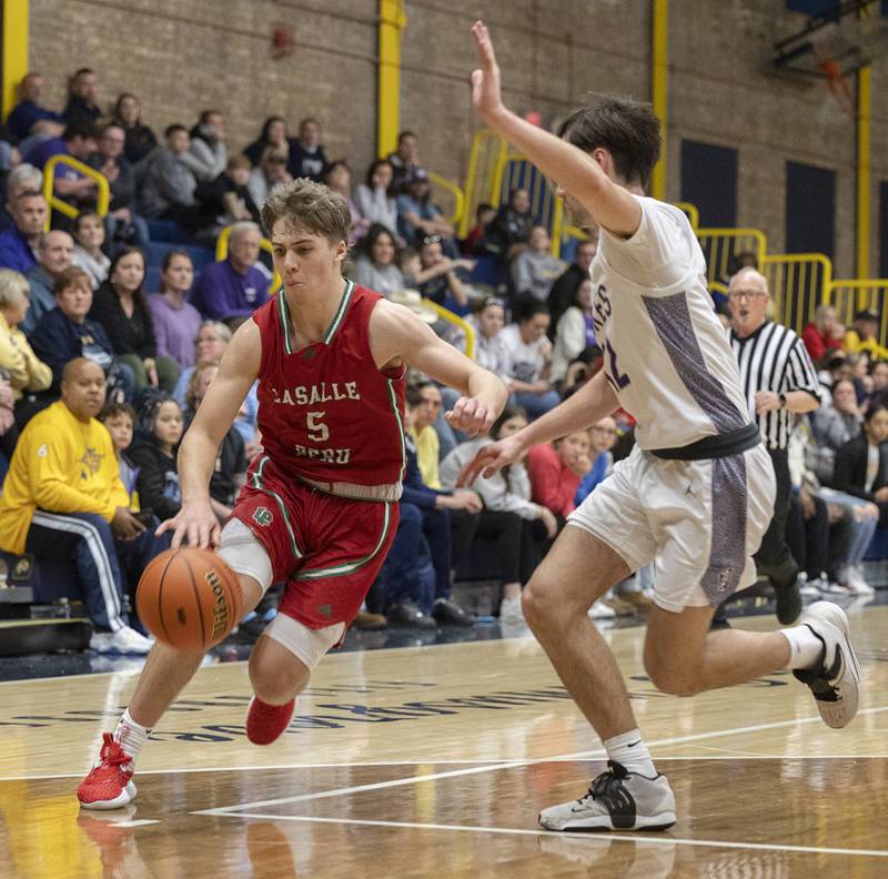 LaSalle-Peru’s Seth Adams drives to the hoop against Dixon’s Bryce Feit Wednesday, Feb. 21, 2024 at the Sterling class 3A basketball regional.