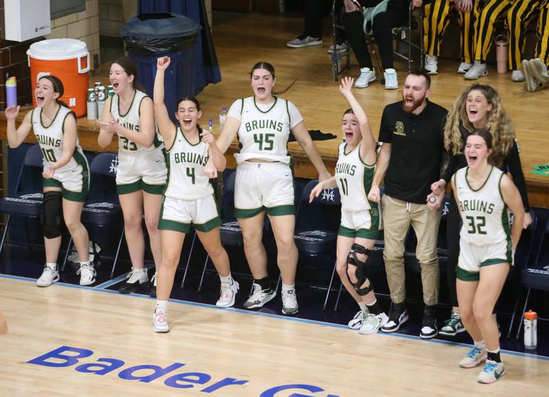 Members of the St. Bede girls basketball team react in the final seconds of the fourth quarter as they defeat Marquette during the Class 1A Regional semifinal game on Monday, Feb,. 12, 2024 in Bader Gym.