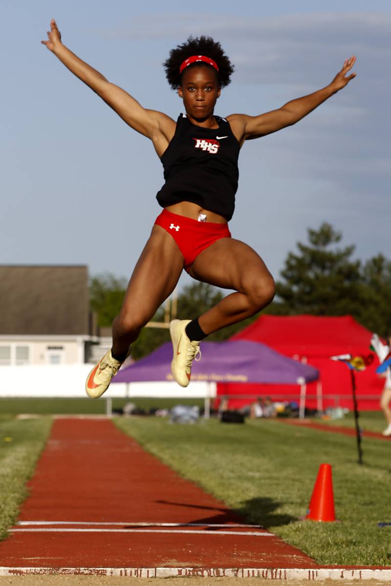 Huntley’s Dominique Johnson flies through the air as she long jumps during the Huntley IHSA Class 3A Girls Sectional Track and Field Meet at Huntley High School.