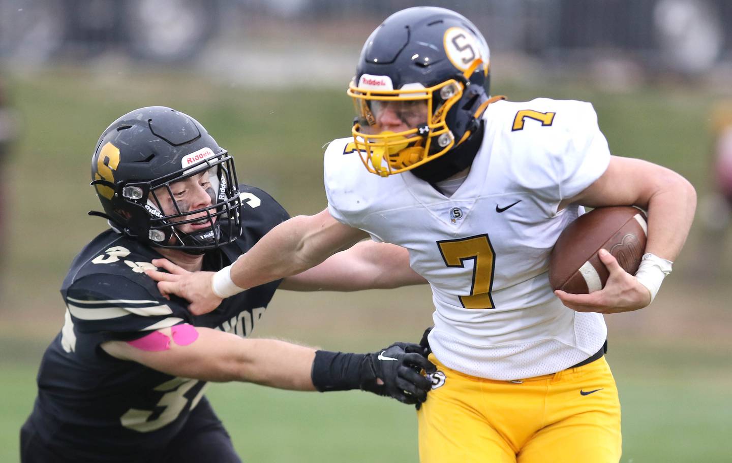 Sterling's Kael Ryan fends off Sycamore's Joey Puleo during their Class 5A state playoff game Saturday, Nov. 12, 2022, at Sycamore High School.