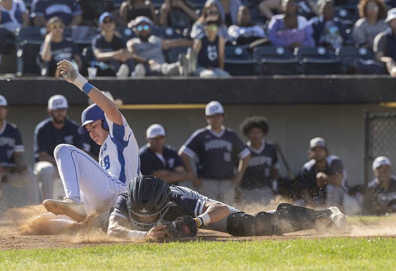 Newman’s Garet Wolfe is out at home as Chicago Hope’s Elias Diaz keeps his foot on the base Monday, May 27, 2024 during the Class 2A super-sectional in Rockford.