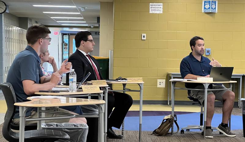 Sycamore Community School District 427 Board of Education members (from left) Alex Grados, Beth Marie Evans and Christian Copple listen as Michael DeVito II speaks during the July 18, 2023 Board of Education meeting at Sycamore Middle School.