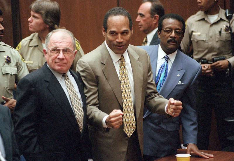 FILE - In this Oct. 3, 1995, file photo, O.J. Simpson reacts as he is found not guilty in the death of his ex-wife Nicole Brown Simpson and her friend Ron Goldman in Los Angeles. Defense attorneys F. Lee Bailey, left, and Johnnie L. Cochran Jr. stand with him. Simpson, the decorated football superstar and Hollywood actor who was acquitted of charges he killed his former wife and her friend but later found liable in a separate civil trial, has died. He was 76. (Myung J. Chun/Los Angeles Daily News via AP, Pool, File)