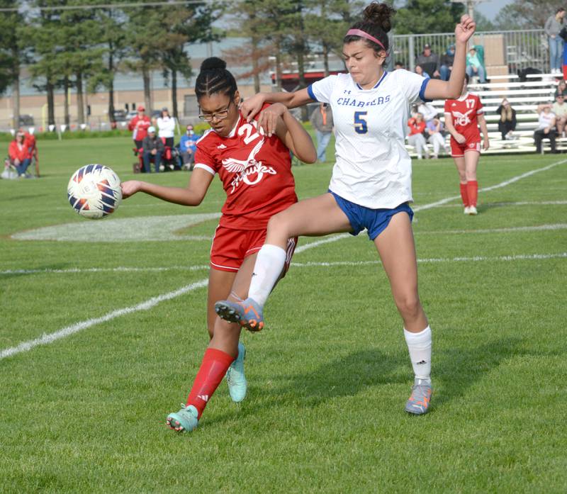 Oregon's Alease McClain (21) battles Aurora Central Catholic's Alexsa Javier for the ball at the 1A Oregon Regional on Tuesday, May 14, 2024. Oregon won the game 4-1, advancing to the Shabbona (Indian Creek) Sectional on Saturday, May 18 where the  Hawks will face Stillman Valley in a noon game.