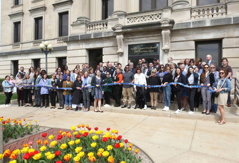 Attendees gather in front of the DeKalb County Courthouse Tuesday, April 16, 2024, during the Hands Around the Courthouse event in Sycamore. The event, hosted by CASA DeKalb County and Family Service Agency of DeKalb County, was held in honor of National Child Abuse Prevention Month.