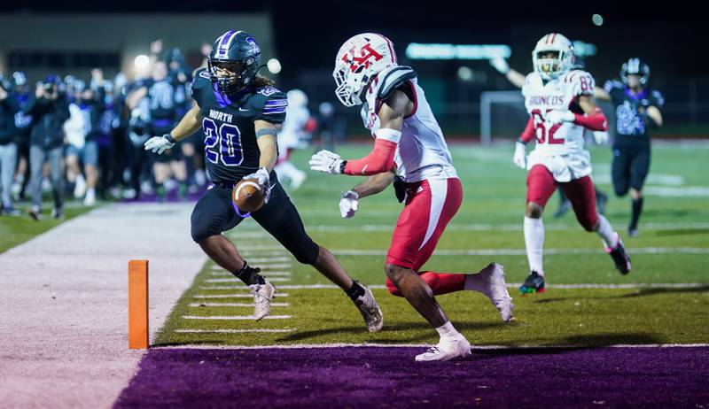 Downers Grove North's Noah Battle (20) runs back an interception for a touchdown against Kenwood during a class 7A playoff football game at Downers Grove North on Friday, Oct. 27, 2023.