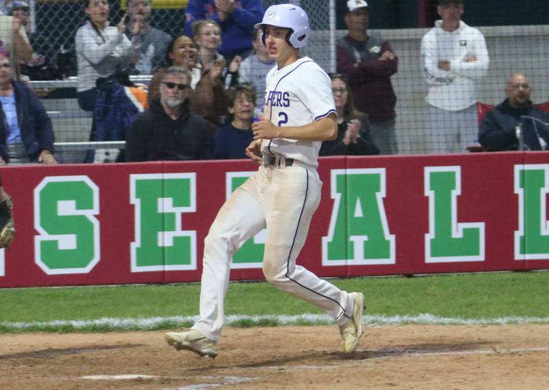Plano's Jake Decker scores the teams second run against Ottawa during the Class 3A Regional semifinal game on Wednesday, May 22, 2024 at Huby Sarver Field in La Salle.