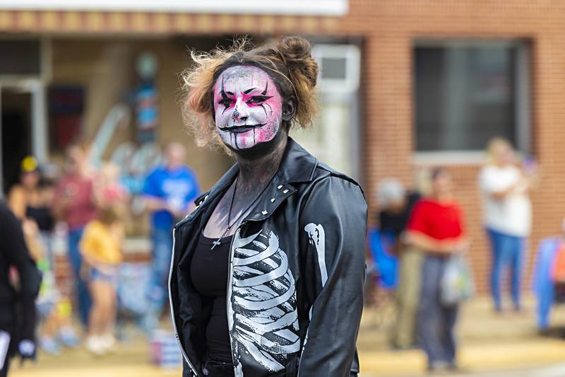 A member of Haunted Haven smiles from behind her make-up while marching through the Fiesta Days parade Saturday, Sept. 16, 2023.