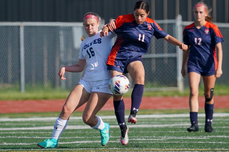 Oswego East's Catie Sloan (16) challenges Oswego’s Dahlia Fuentes (11) for the ball during a Class 3A Lockport Regional semifinal soccer match at Lockport High School in Lockport on Wednesday, May 15, 2024.