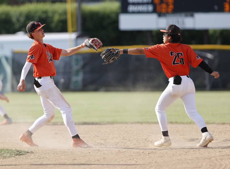 St. Charles East's Antonio Perez (26) congratulates James Feigleson (27) after a caught stealing play during the Class 4A York regional semi-final between Wheaton Warrenville South and St. Charles East in Elmhurst on Thursday, May 23, 2024.