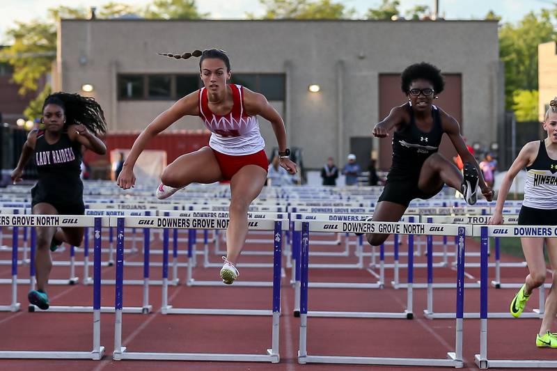 Naperville Central's Brooke Sawatzky wins in the 100-meter hurdles with Oswego East's Layla Brisbon coming in second  at Friday's Class 3A Downers Grove North Sectional girls track and field meet.