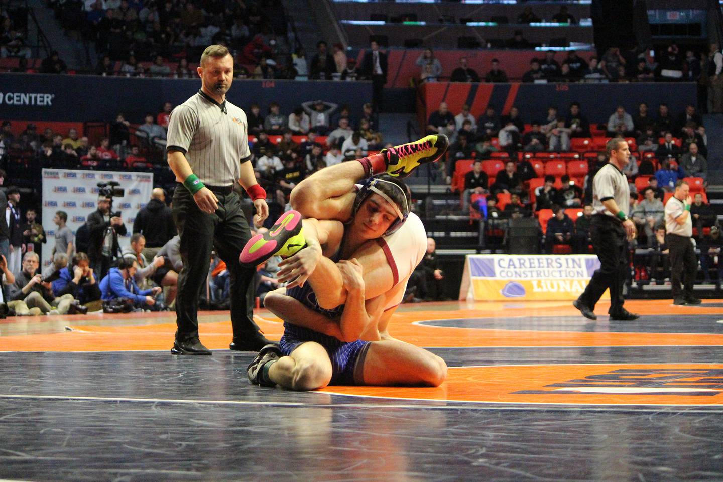 Newman's Carter Rude flips over Benton's Mason Tieffel in their 138-pound title bout at the IHSA Individual State Finals on Saturday, Feb. 18, 2023 at State Farm Center in Champaign.