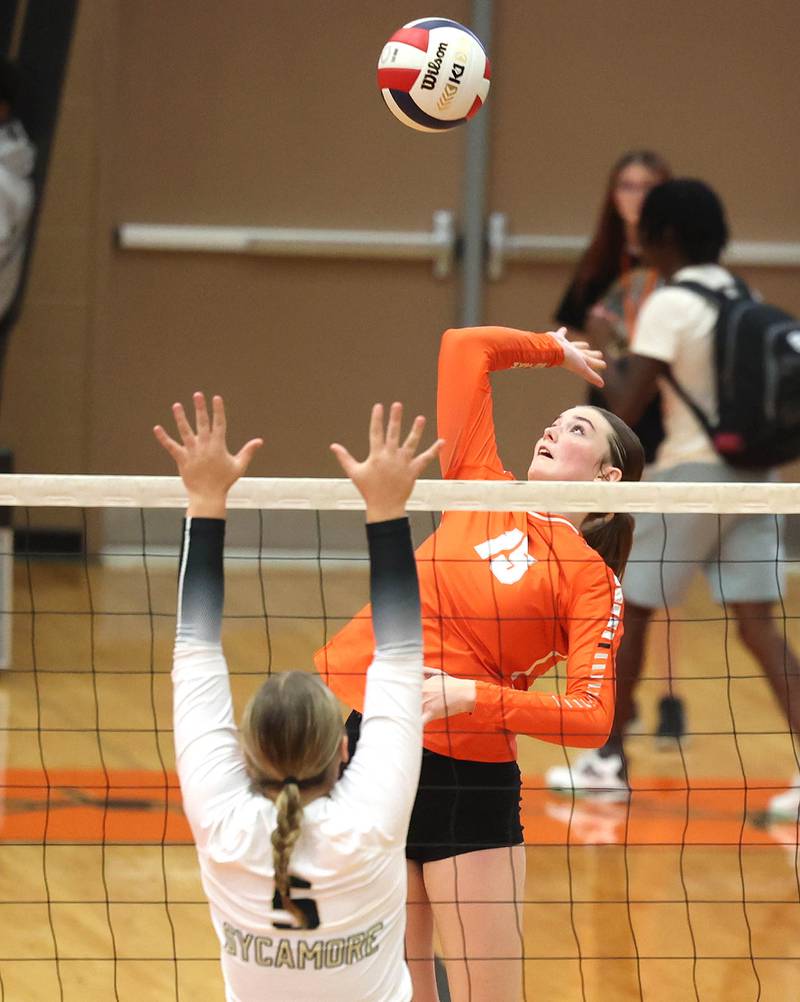 DeKalb's Ava Wente tries to spike the ball past Sycamore's Kylie Walsh during their match Wednesday, Aug. 28, 2024, at DeKalb High School.