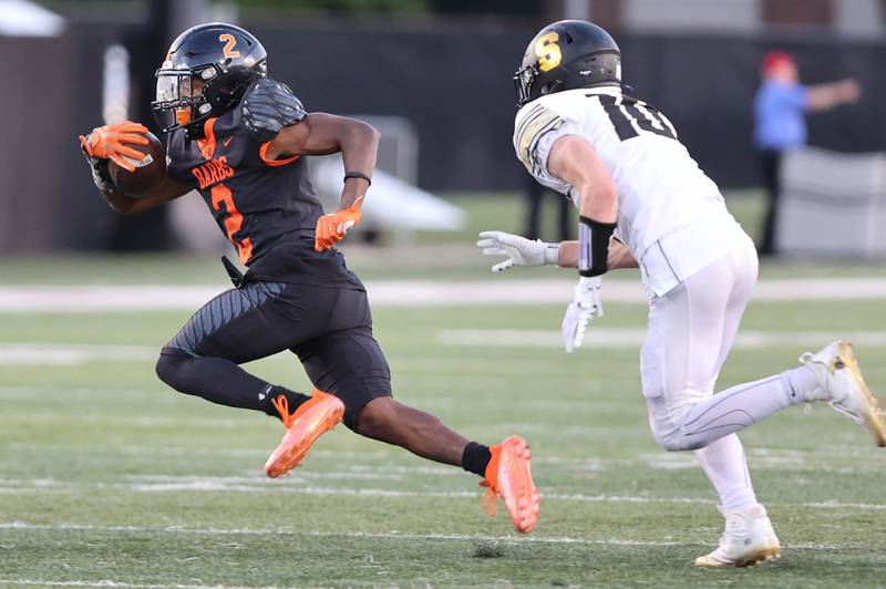 DeKalb's Jamari Brown runs away from Sycamore's Zack Crawford during the First National Challenge Friday, Aug. 26, 2022, in Huskie Stadium at Northern Illinois University in DeKalb.