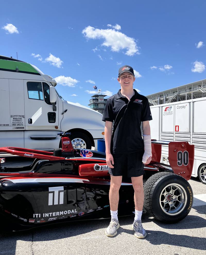 Evan Cooley, of Frankfort, stands by his USF 2000 race car after a race earlier this month at the Indianapolis Motor Speedway, which left him with a bruised left hand.