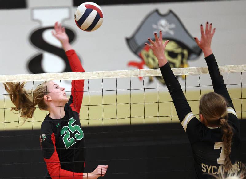 LaSalle-Peru's Addison Urbanski tries to spike it by Sycamore's Laci Neece during their match Tuesday, Oct. 10, 2023, at Sycamore High School.