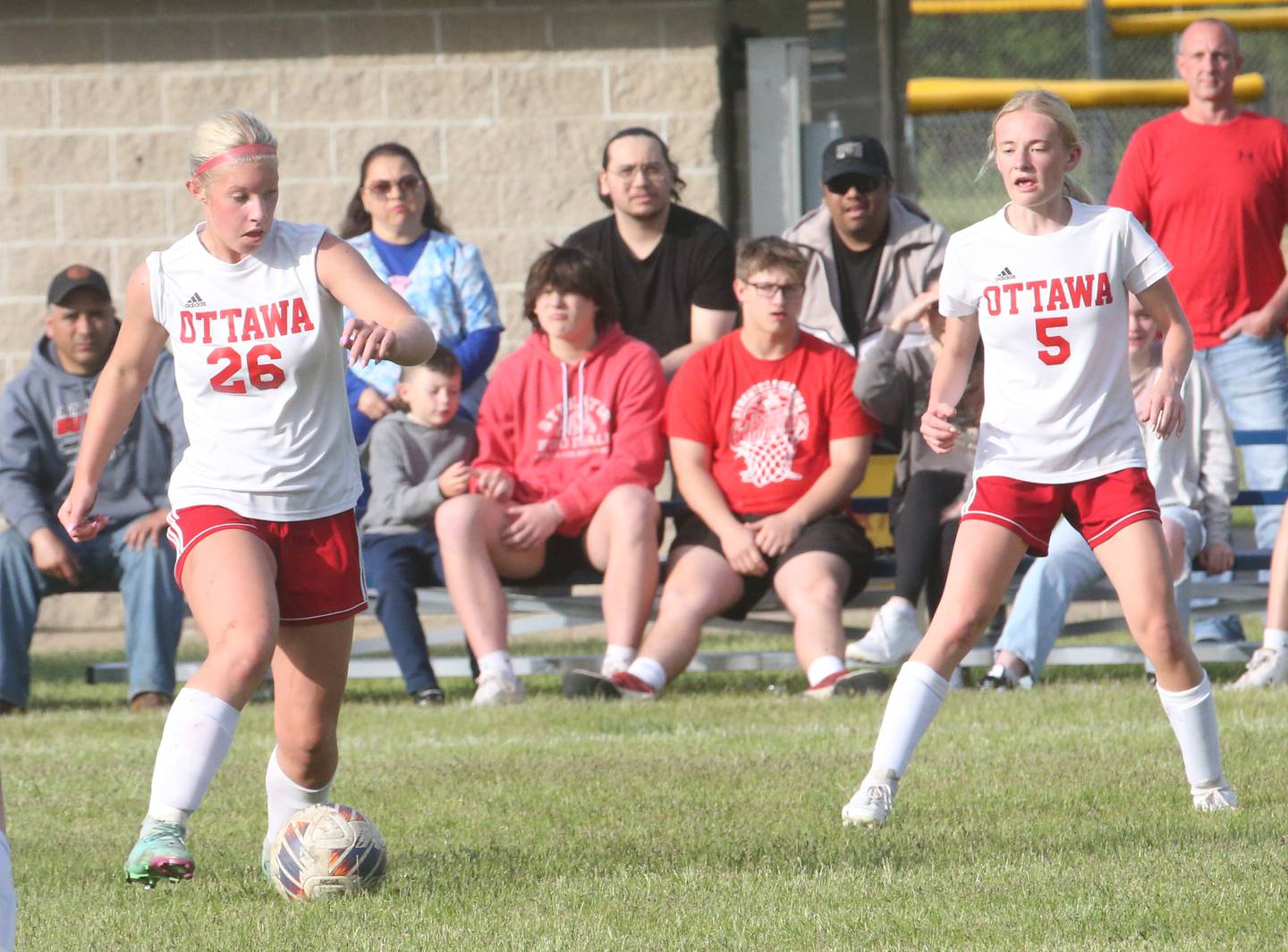 Ottawa's Taylor Brandt (26) pushes the ball ahead to teammate Anastacia Zegis on Friday, May 10, 2024, at James Street Recreation Area in Streator.