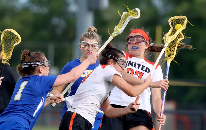 Crystal Lake Central’s Colleen Dunlea, center, and Anna Starr, right, move the ball against Lake Forest during girls lacrosse supersectional action at Metcalf Field on the campus of Crystal Lake Central Tuesday.
