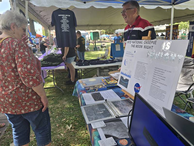 NASA Ambassador Scott Pellican of La Salle speaks Saturday, Sept. 14, 2024, to Margaret Moore of Streator about the moon. Pellican shared astronomical information during the Pluto Festival in Streator's City Park.