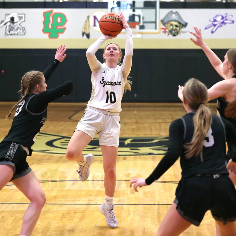 Sycamore's Lexi Carlsen shoots between three Kaneland defenders during their Class 3A sectional semifinal Tuesday, Feb. 20, 2024, at Sycamore High School.