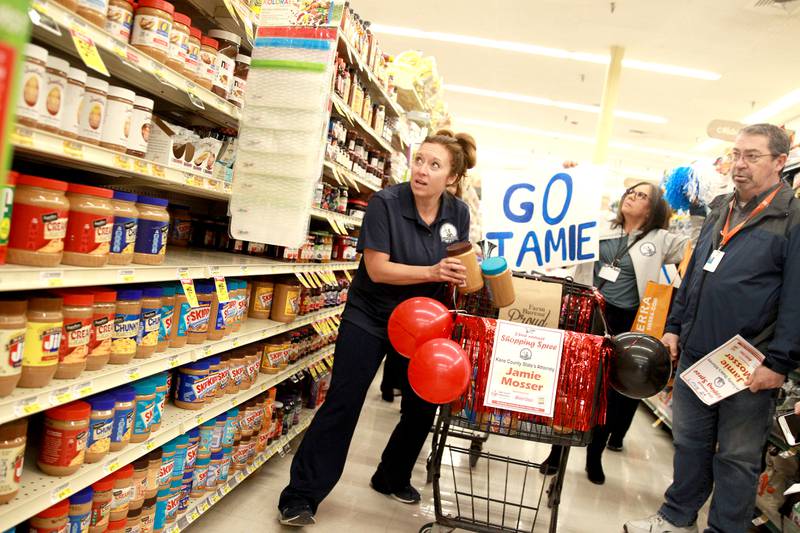 Kane County State’s Attorney Jamie Mosser loads her cart with peanut butter during the Kane County Farm Bureau's 23rd Check Out Shopping Spree at the Jewel-Osco in Batavia on Monday, Feb. 26, 2024. Mosser collected food for Elgin's Community Crisis Center.​