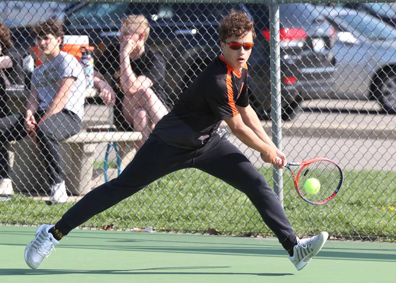 DeKalb number one singles player Rylan Lottes runs down a ball Wednesday, April 26, 2023, during their match at Sycamore High School.