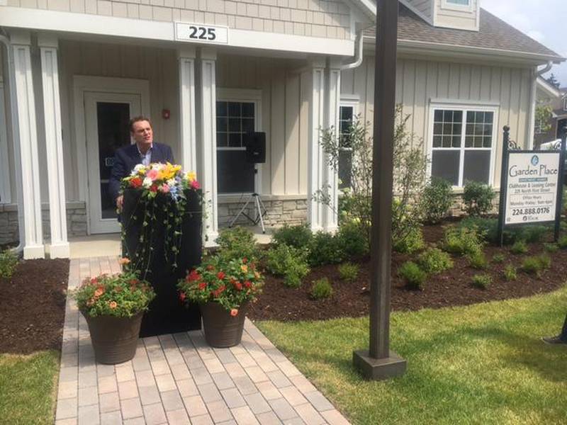 Pedcor Executive Vice President Tom Crowe addresses an audience at the ribbon cutting of the Garden Place apartment complex Thursday, Aug. 3, 2017.