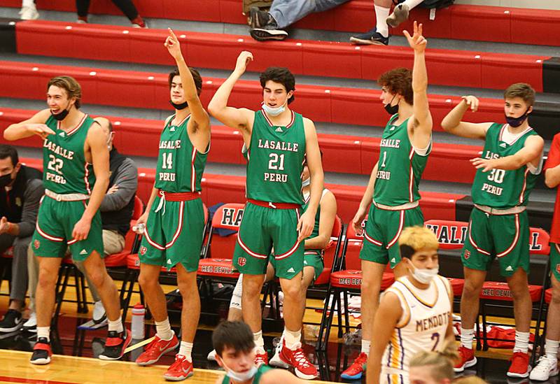 Members of the L-P boys basketball team cheer on their team against Mendota during the 47th Colmone Classic tournament on Tuesday Dec. 7, 2021 at Hall High School in Spring Valley.