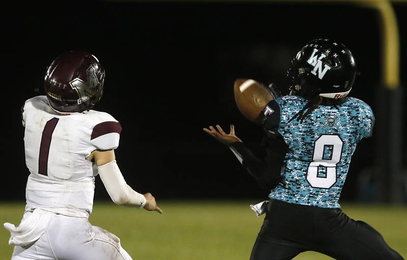 Woodstock North's Maxwell Dennison catches a pass in front of Marengo's David Lopez during a Kishwaukee River Conference football game on Friday, Sept. 13, 2024, at Woodstock North High School.