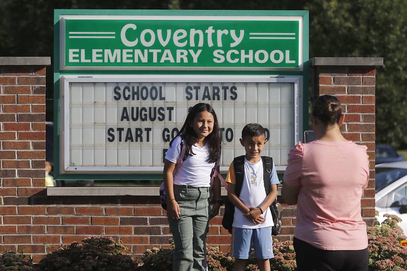 Magaly Horta, photographs her children Ximena, 7, and Valentin, 6, before the first day of school on Wednesday, Aug. 21, 2024, at Coventry Elementary School in Crystal Lake.