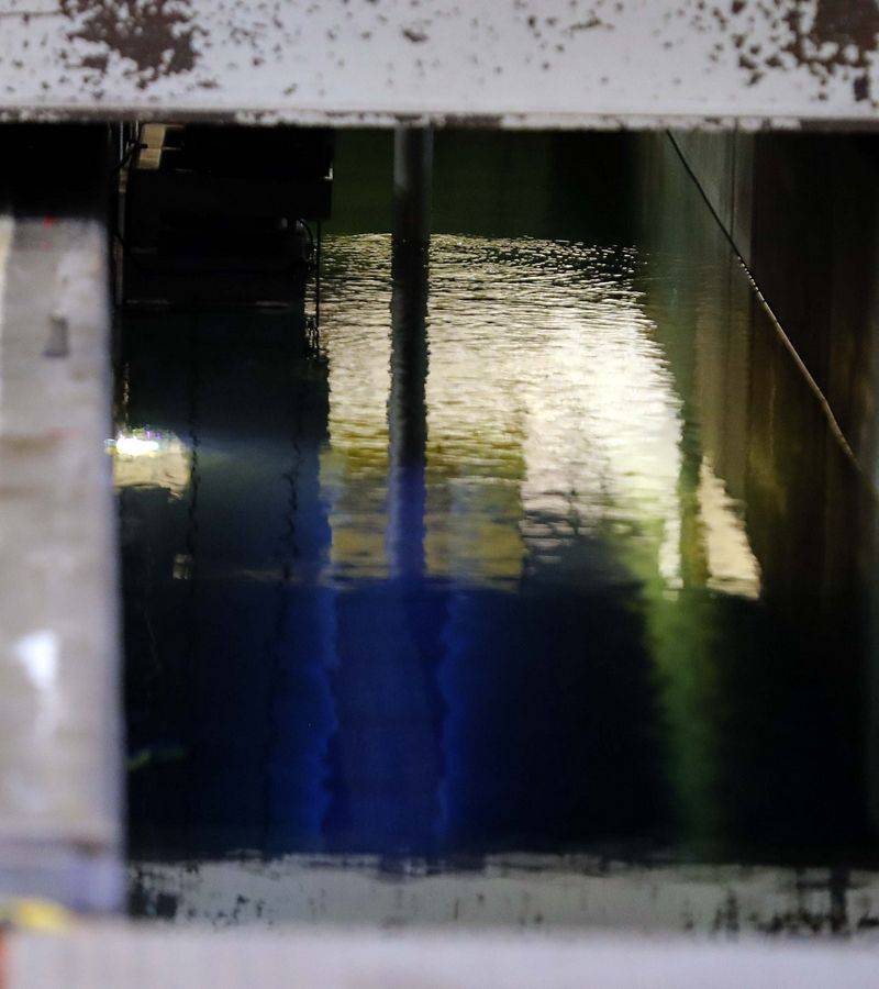 A slight blue glow can be seen from a used fuel cell as it is moved through the cooling pool at the Byron Generating Station Tuesday, Oct. 17, 2023, in Byron.