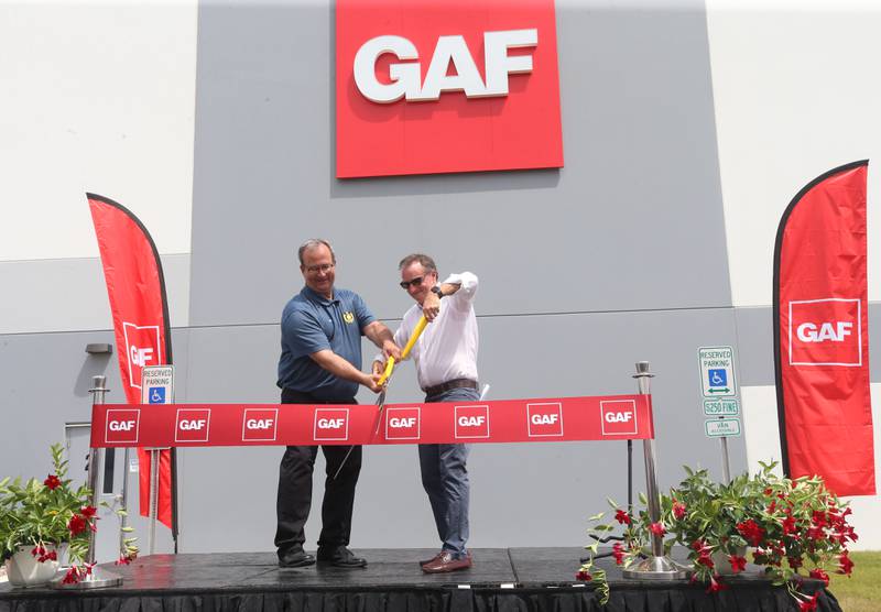 Peru mayor Ken Kolowski and GAF CEO John Altmeyer cut the ribbon during a grand opening celebration at the GAF facility on Tuesday, July 16, 2024 in Peru.