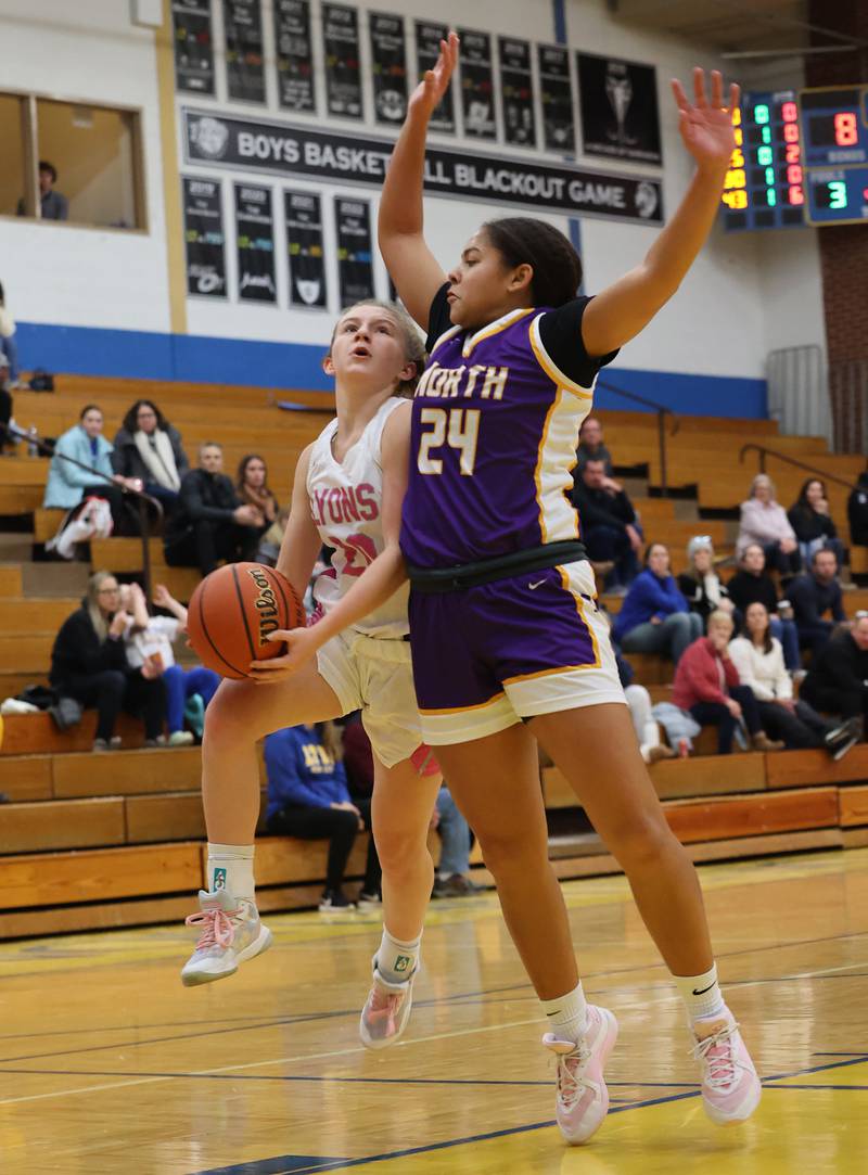 Lyons’ Avery Mezan (20) is stopped by Downers Grove North’s Kaitlyn Parker (24) during the girls varsity basketball game on Tuesday, Jan. 16, 2024 in La Grange, IL.