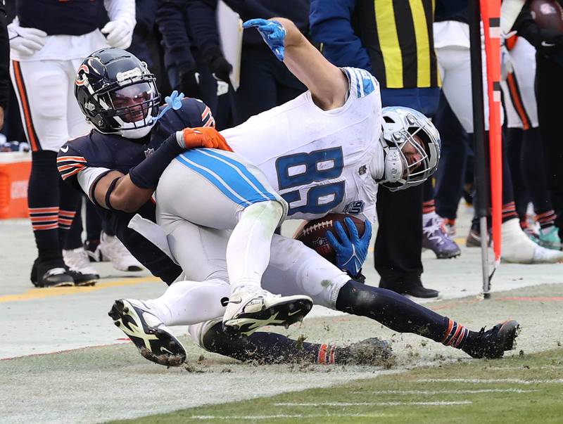 Chicago Bears safety Jaquan Brisker brings down Detroit Lions tight end Brock Wright during their game Sunday, Dec. 10, 2023 at Soldier Field in Chicago.