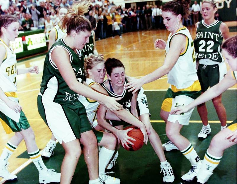 St. Bede and Seneca players try to secure a loose ball during the Supersectional game on Feb. 21, 2000.