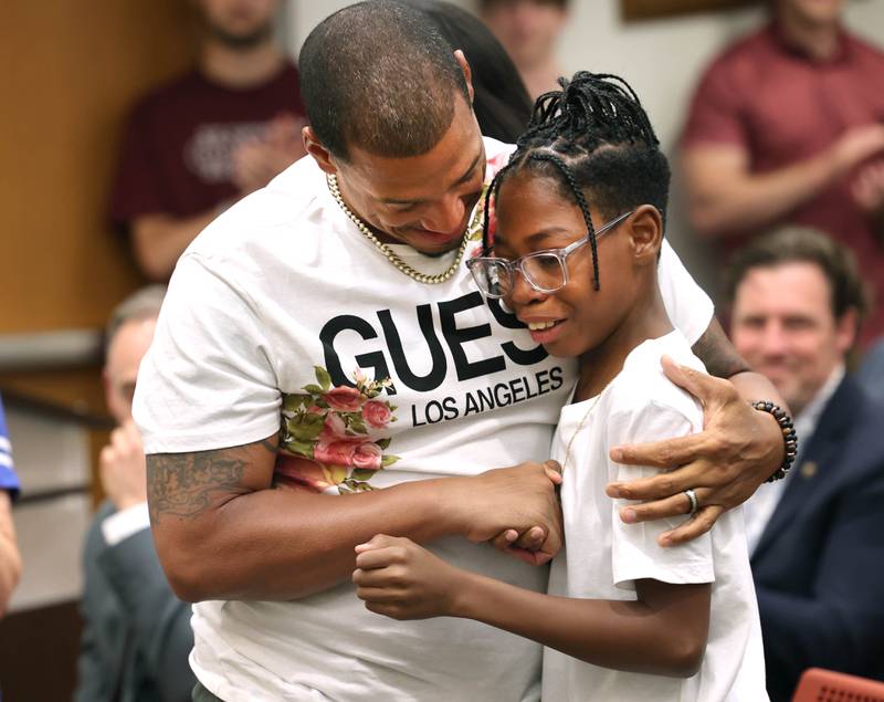 Ward 7 Alderman John Walker hugs Elijah Livingston after Livingston learned his wish was granted by Make-A-Wish Illinois Monday, July 10, 2023, during the DeKalb City Council meeting. Livingston also received a key to the city from Mayor Cohen Barnes.