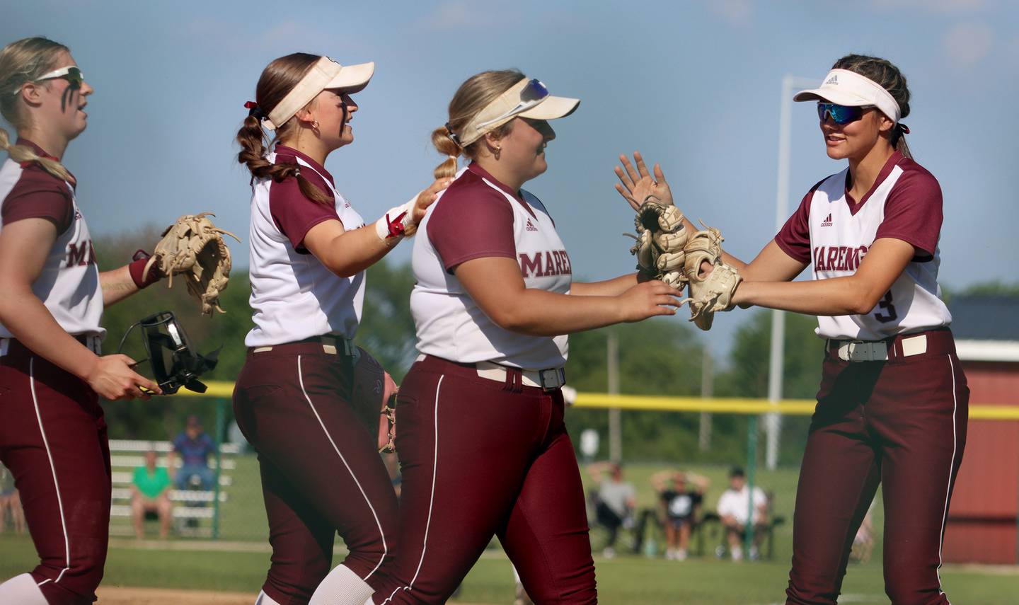 Marengo players, from left, Lilly Kunzer, Gabby Christopher, Emily White and Marissa Young arrive at the dugout at the end of an inning against North Boone in IHSA Softball Class 2A Regional Championship action at Marengo Friday.