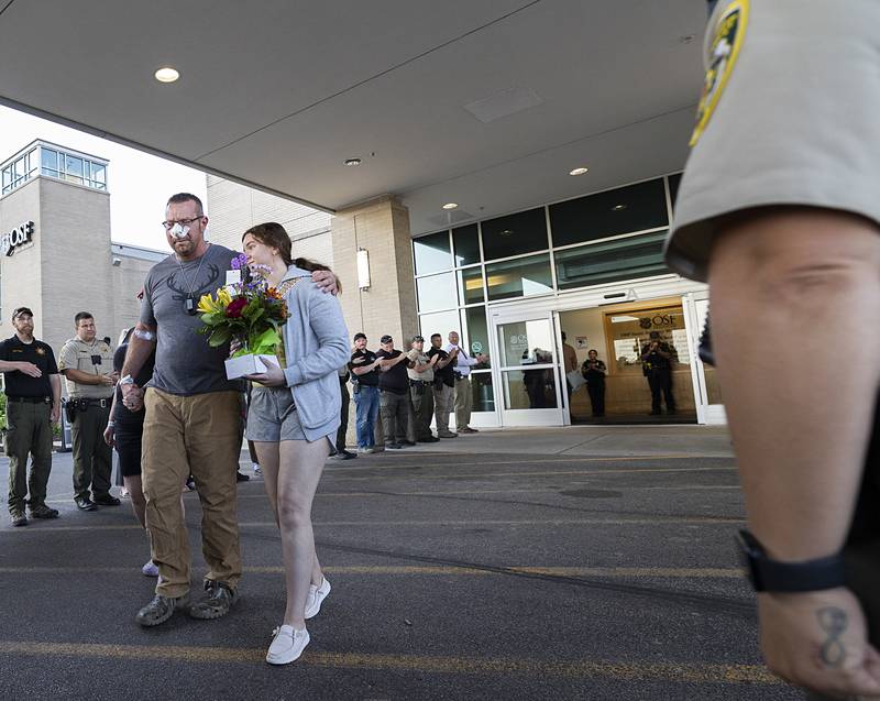 Lt. Jason Ketter received a respectful salute before being applauded by his fellow law enforcement officers as he leaves OSF Medical Center in Rockford on Friday, June 14, 2024.