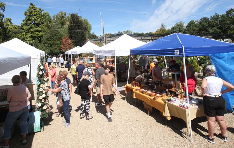 People walk around the Artisan Market on Saturday, Sept. 14, 2024 at Hornbakers in Princeton.