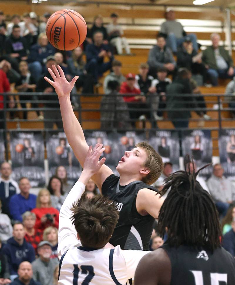 Kaneland's Troyer Carlson shoots over Belvidere North's Robert Koeller Wednesday, Feb. 28, 2024, during their Class 3A sectional semifinal game at Kaneland High School in Maple Park.