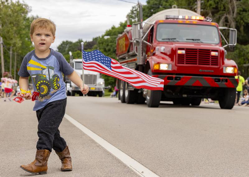 Brantley Neisewander searches for candy Saturday, June 8, 2024, during the parade route at the Buffalo Days in La Moille.