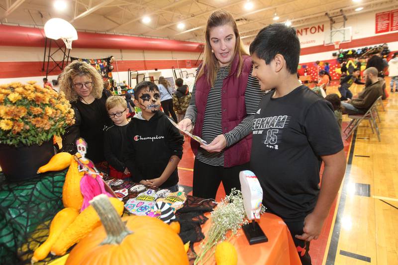 Carol Bennett, principal of Gavin Central Elementary School, and Mary Orozco, EL teacher at Gavin Central, both of Round Lake Beach, talk with Phillip Day, 8, Jesus Osorio, 7, both of Ingleside and Emiliano Cerna, 9, of Fox Lake about the artwork featured on Gavin Central's altar during the Dia de los Muertos, Day of the Dead event at Stanton Middle School on November 4th in Fox Lake. The event was sponsored by the Bilingual Parents Advisory Committee (BPAC) from School Districts 114,124 and 37.
Photo by Candace H. Johnson for Shaw Local News Network