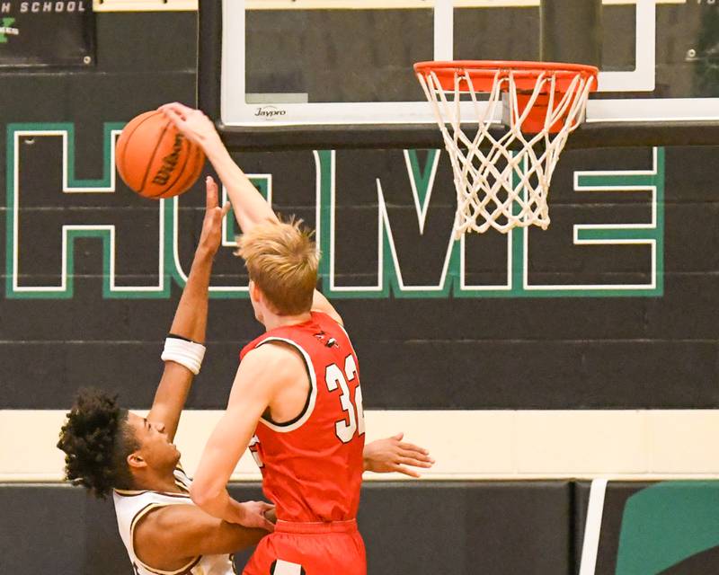 Yorkville's Jason Jakstys (32) blocks the shot of St. Ignatius's Phoenix Gill (13) during the first quarter during the Jack Tosh tournament on Tuesday Dec. 26, 2023, held at York High School in Elmhurst.