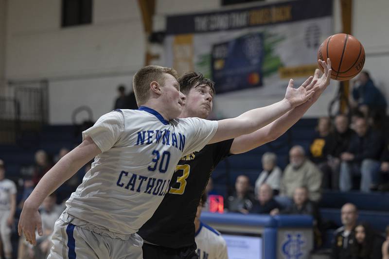 Newman’s Dax Snyder and AFC’s Brock Lehman reach for a rebound Monday, Feb. 19, 2024 in a regional quarterfinal game at Newman High School.