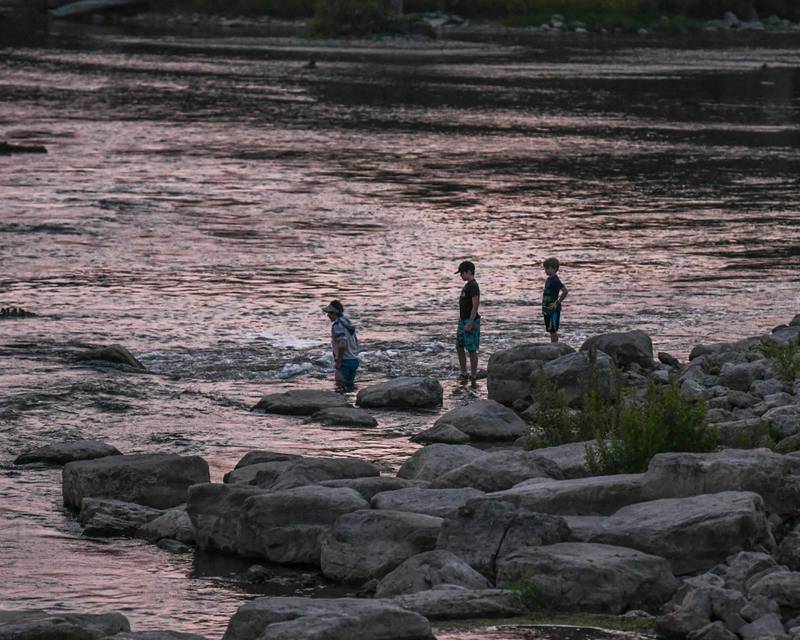 Friends and baseball teammates, from left to right, Cole Mercurio, 12, of Yorkville Ryan Tumilty, 12, and brother Cameron Tumilty, 8, of Oswego enjoy getting their feet wet during the warm weather night as the Summer Solstice  Music Festival takes place on Friday June 23, 2023 in Downtown Yorkville