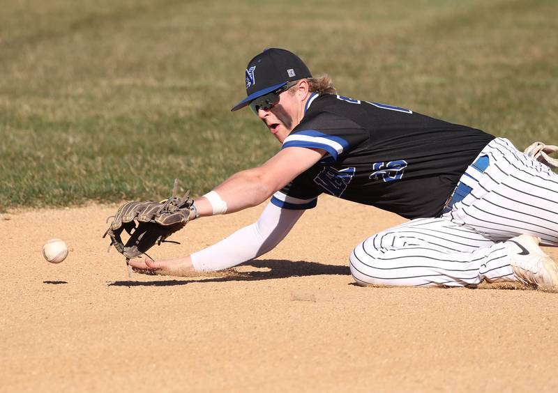 Newark's Clay Friestad dives for a ball at shortstop Monday, April 8, 2024, during their game at Hinckley-Big Rock High School.