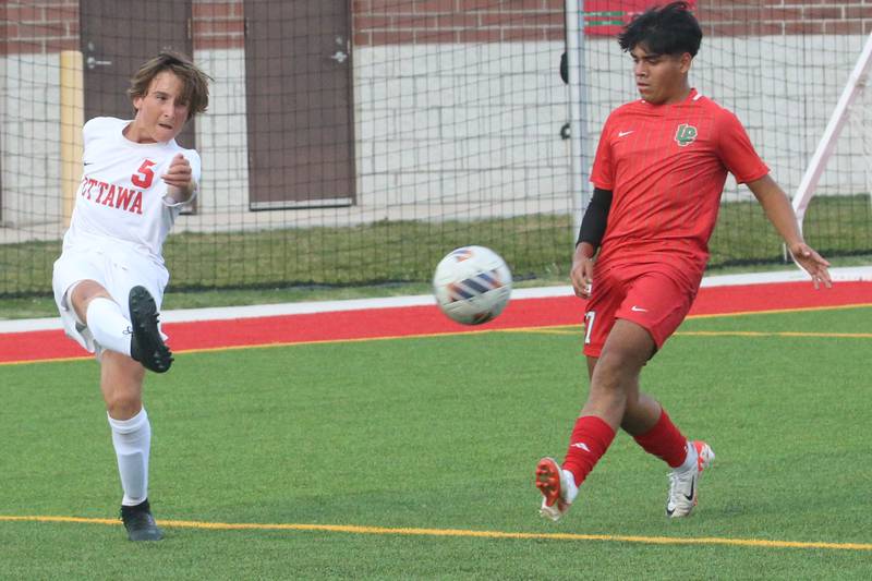 Ottawa's Rory Moore kicks the ball in front of L-P's Alex Rax on Wednesday, Sept. 18, 2024 at the L-P Athletic Complex in La Salle.