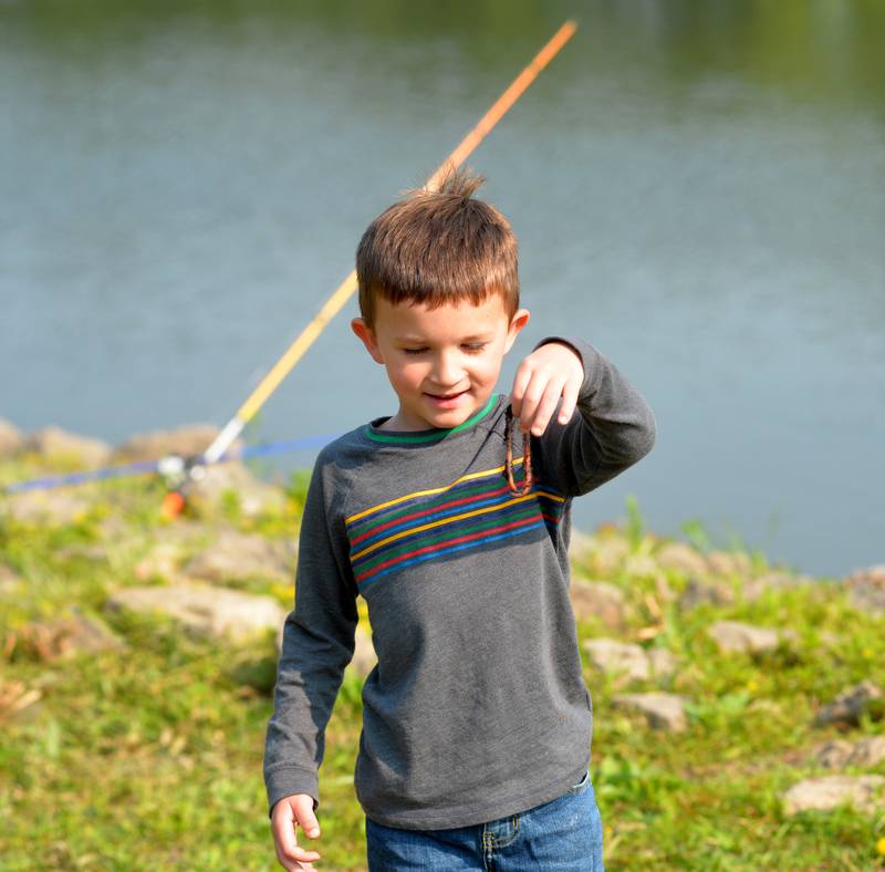 Andrew Morgan, 5, of Sterling, holds a nightcrawler as he takes part in the 17th Dick Brown Fishing Derby for kids at Prophetstown State Park on Saturday.